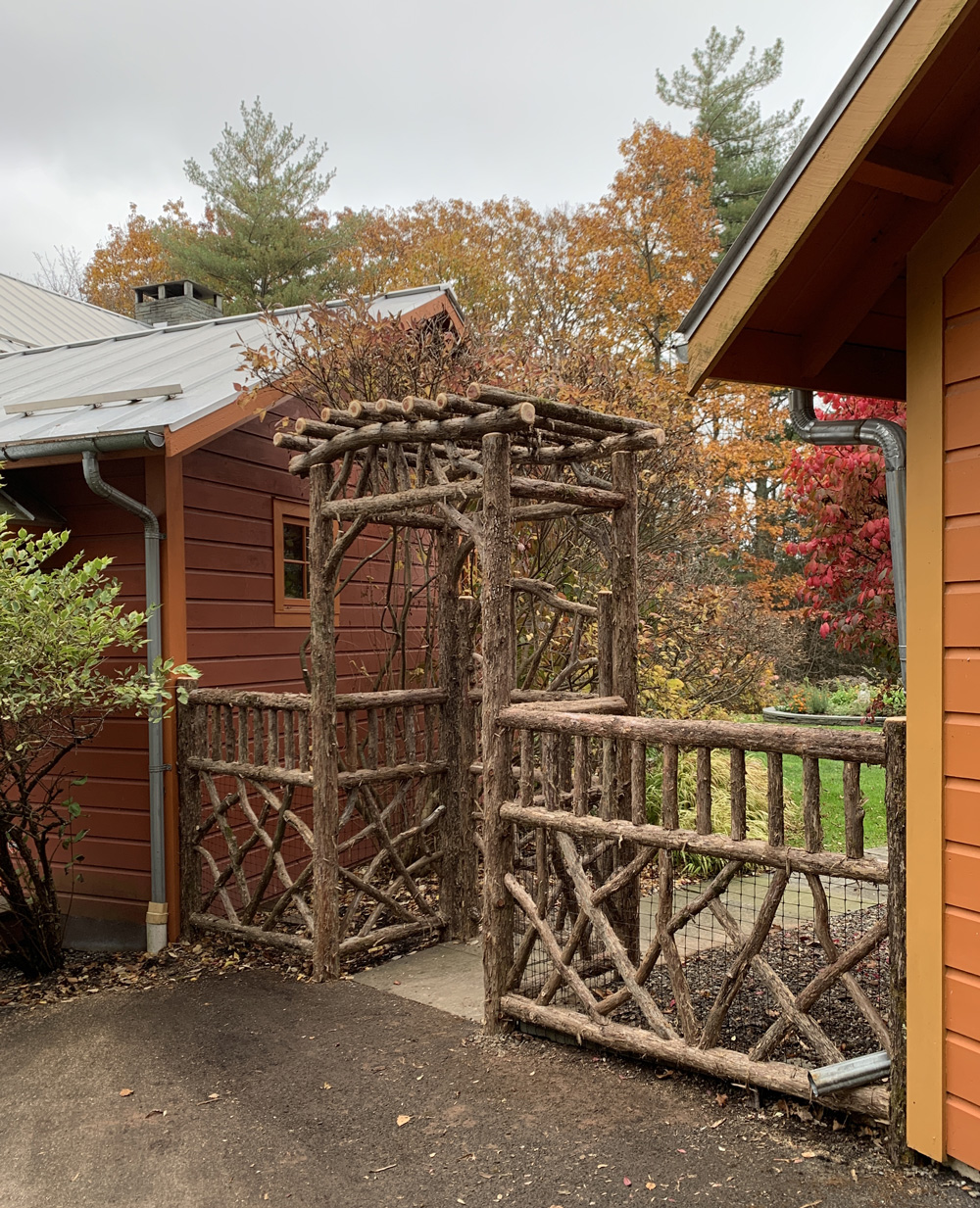 Rustic natural arbor and fencing made from bark-on cedar logs, twigs, and branches titled the Glasco