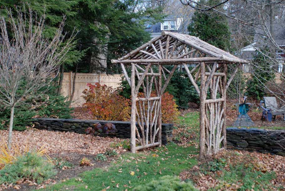 Natural wood rustic arbor built with trees and branches titled the Hudson