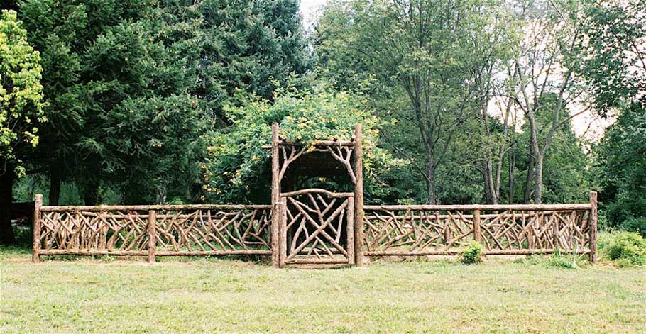 Rustic garden fencing built using bark-on trees and branches titled Chui's Garden