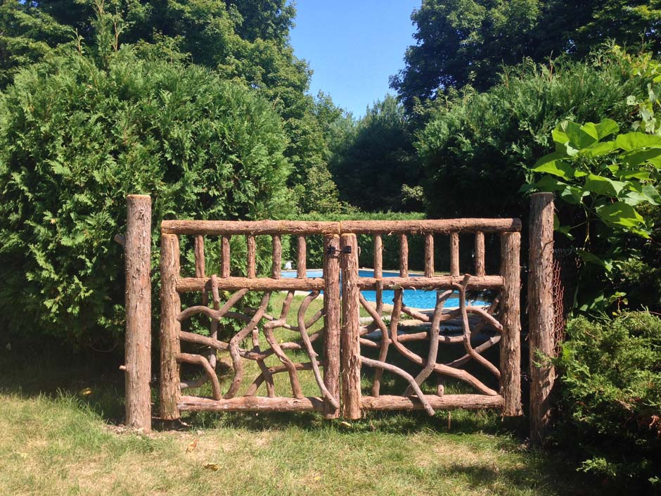 Natural wood gates built with trees and branches titled Palenville Gates