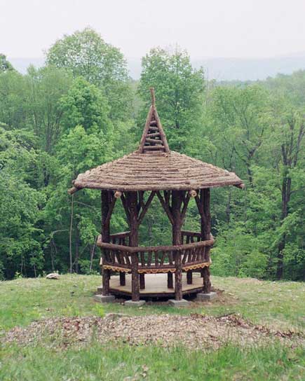 Rustic gazebo built using bark-on trees and branches titled the Applebaum Summerhouse