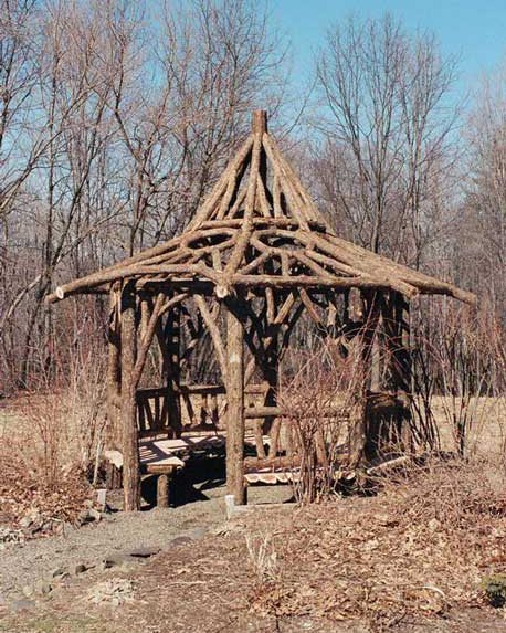 A gazebo built in the rustic style using logs and branches installed at Chui's Summerhouse