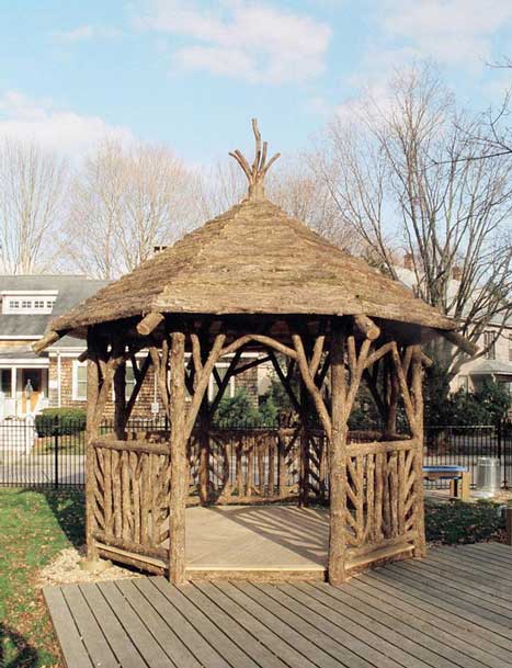Pavilion built in the rustic style using logs and branches installed at Easton Children's Garden
