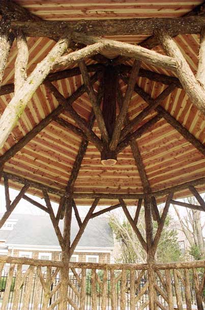 A detail of the roof of a pavilion built in the rustic style using logs and branches installed at Easton Children's Garden