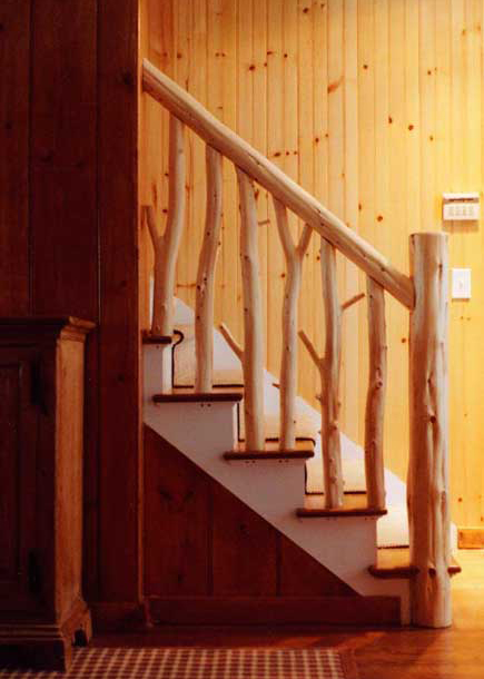 Interior stair railing built with eastern red cedar trees stripped of its bark