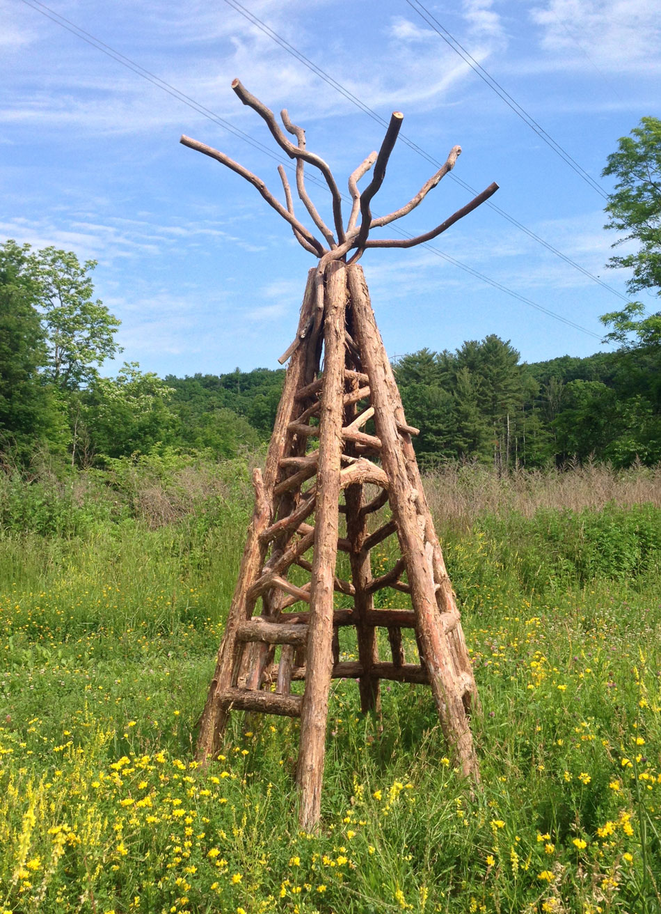 Natural wood tepee built with trees and branches titled the Kend Tepee