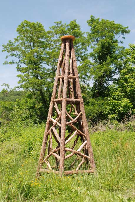 Outdoor tepee in the rustic style using logs and branches titled Newtown Tepee