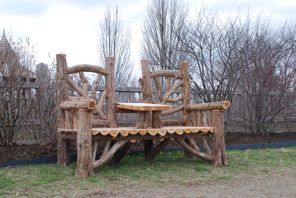 Rustic bench custom built using cedar trees and branches titled the Couple's