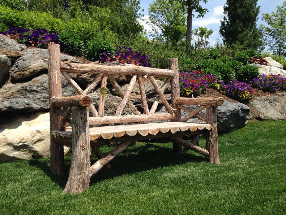 Outdoor park bench built in the rustic style using logs and branches titled the Milan