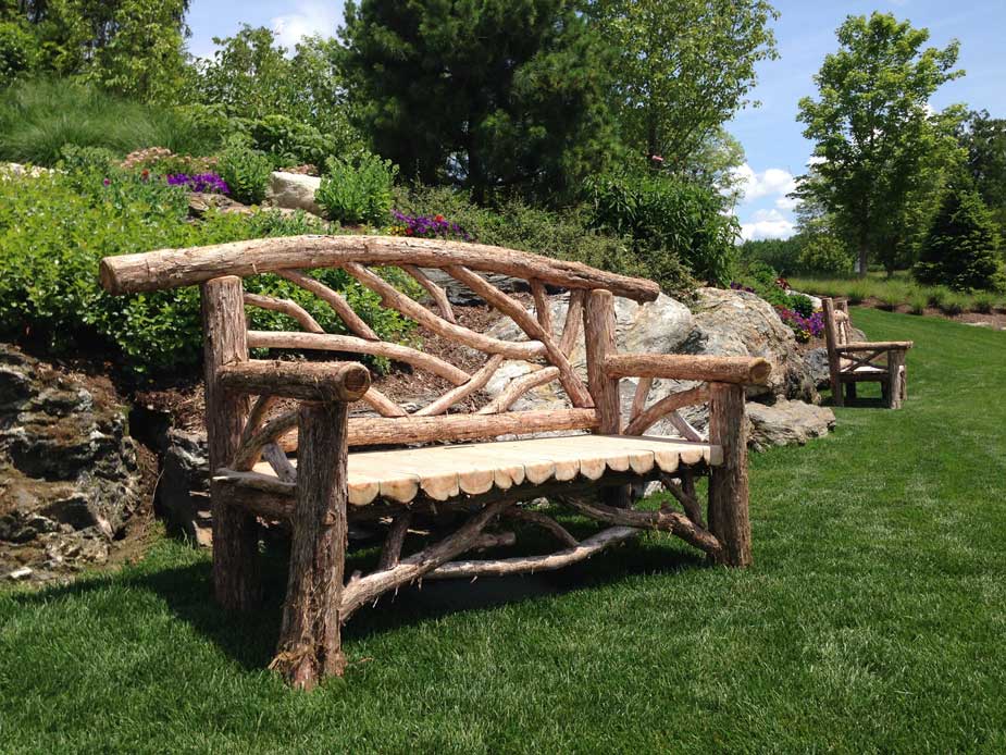 Outdoor rustic garden bench built using bark-on trees and branches titled the Rhinecliff