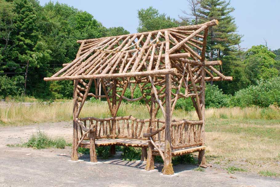 Outdoor sitting shelter built in the rustic style using logs and branches built for Disney Resort in Florida