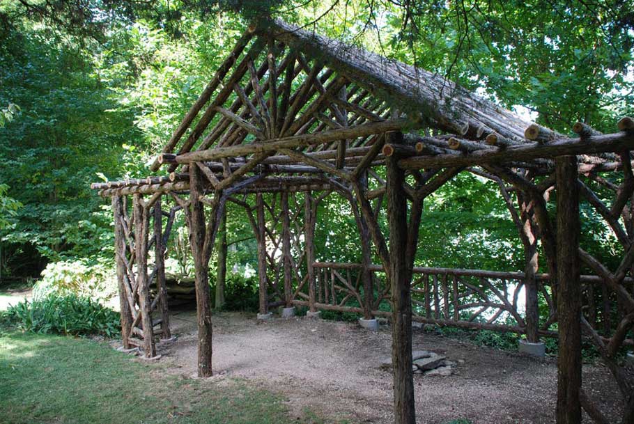 Rustic dining pavilion custom built using cedar trees and branches titled the Martin Dining Pavilion