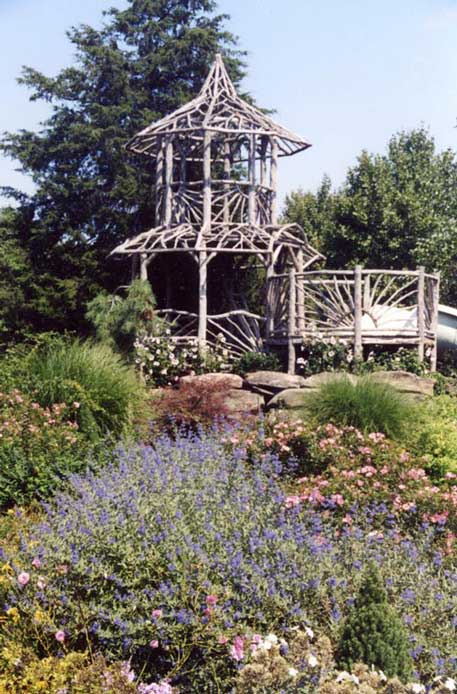 Natural wood two story gazebo built with trees and branches titled the Murphy Tree Tower